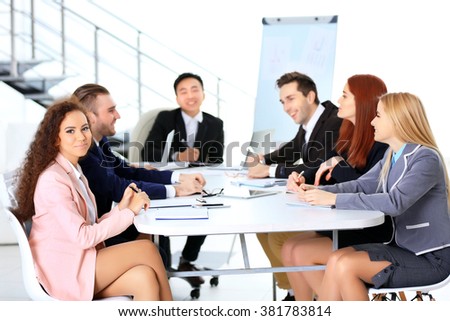 Young colleagues sitting at the business meeting in the office