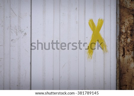 Old container surface with X letter
