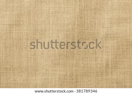 Jute hessian sackcloth woven organic burlap, hemp flax texture pattern background in light cream yellow beige brown color  Royalty-Free Stock Photo #381789346