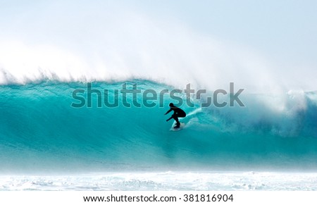 Surfer tube-ride at Cape Town. Royalty-Free Stock Photo #381816904
