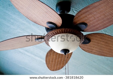 Decorative ceiling fan on porch of home. Royalty-Free Stock Photo #381818620