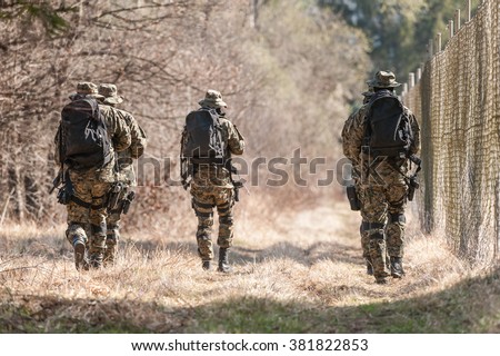 Patrol police-military units on the fence Royalty-Free Stock Photo #381822853