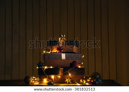 Gift boxes and Christmas decor on wall background