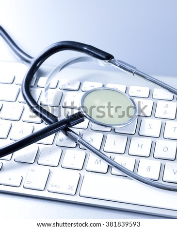 Computer keypad and stethoscope, toned image. IT support or research theme.
