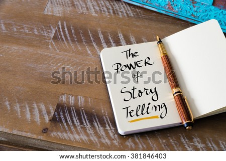 Retro effect and toned image of notebook next to a fountain pen. Business concept image with handwritten text THE POWER OF STORY TELLING , copy space available Royalty-Free Stock Photo #381846403