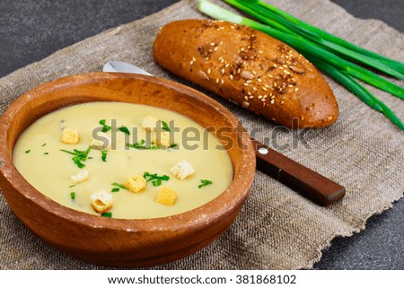 Healthy, diet food: soup of potatoes with croutons, bread and greens. Studio Photo