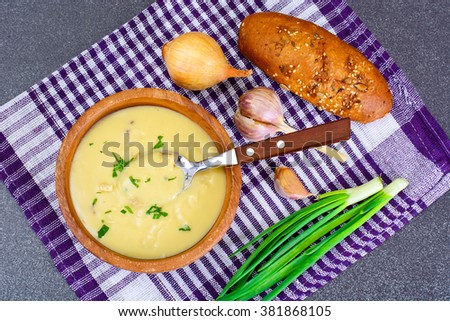 Healthy, diet food: soup of potatoes with croutons, bread and greens. Studio Photo