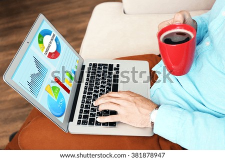 Businessman working with modern laptop, with scheme on screen