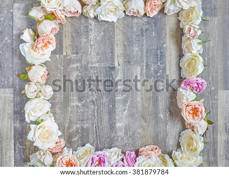 Pink white purple roses square frame over wooden table. Inside view with copy space