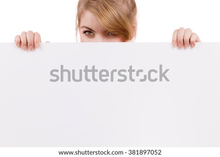 Woman with blank presentation board. Female model showing banner sign billboard copy space for text,  looking down at it. Advertisement concept.