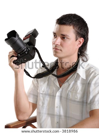 young man photographer holding a photo camera. Isolated over white background