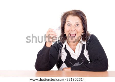 beautiful senior woman with glass of milk isolated in white