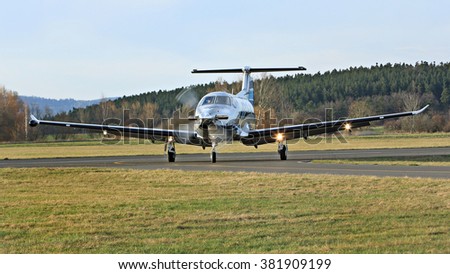Turboprop aircraft on the runway at small airport Royalty-Free Stock Photo #381909199