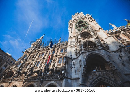 Beautiful multicolored downtown picture of street in Munich, Bayern, Bavaria, Germany, leading to Marienplatz, with tourists and people walking near shop-windows and restaurants, sunny summer day 