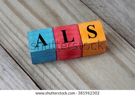 ALS (Amyotrophic Lateral Sclerosis) acronym on colorful wooden c Royalty-Free Stock Photo #381962302