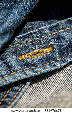 Denim Jean Shirt with Buttonhole. Background and Textures. Concept and Idea of Denim Industry, Sewing and Vintage Fashion Style. Pattern and Wallpaper. Macro, Selective, Close up Shot.