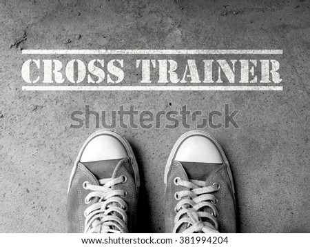 Sneakers on concrete floor background with text : Cross trainer
