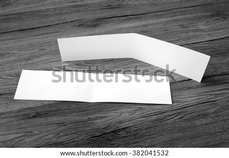White empty card on wooden background to replace your design