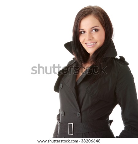 Fashion model in black coat with orthodontic appliance over white background