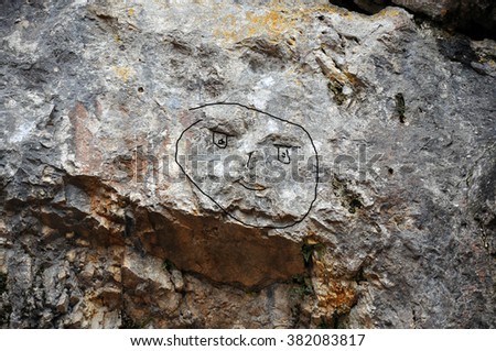 Smiley face on the rock of a mountain