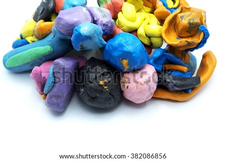 Pieces of plasticine, isolated on white background. Focus on front pieces. Space for texts.