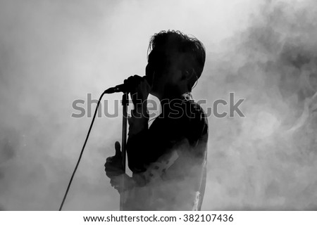 Singer in silhouette Royalty-Free Stock Photo #382107436