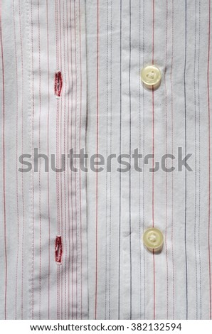 Buttons and holes in striped shirt