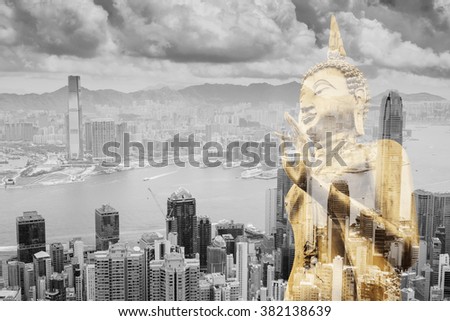 Double exposure. Golden image of Buddha on big city and building background.