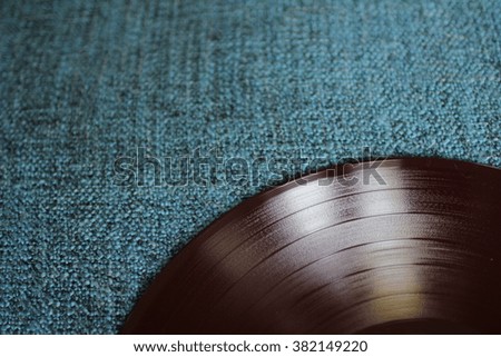 Dark red vinyl records on the dark blue textured background, vintage filter