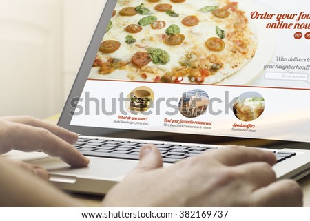 online business concept: man using a laptop with order food online website on the screen. Screen graphics are made up.