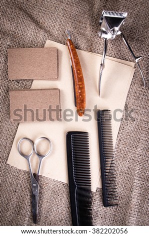 Vintage barber tools on fabric background. Vintage barber equipment with  blank paper.