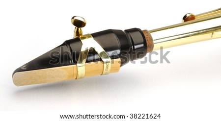 Alto saxophone mouthpiece with reed on white background