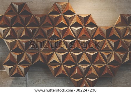 abstract tetrahedron made out of wood pyramids.