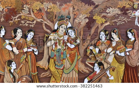 Raised crafted Indian Hindu Gods Krishna and Radha on wood, whole background Royalty-Free Stock Photo #382251463