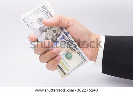 US dollars in business hand isolated on a white background