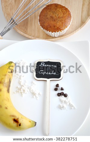 Banana cupcake sign banana on white plate and banana cupcake with whisk on wooden plate