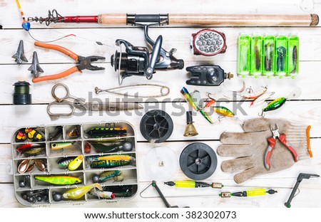 Various fisherman's equipment on wooden background Royalty-Free Stock Photo #382302073