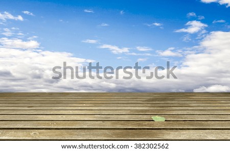Cloudy blue sky and wood floor, background image.
