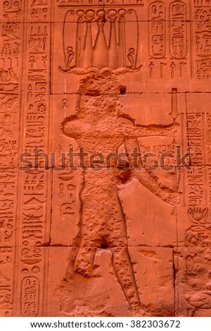 Authentic Hieroglyphic illustration of the Egyptian god on the wall in a temple