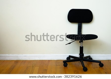 Black chair with wheel in room. Business interior background