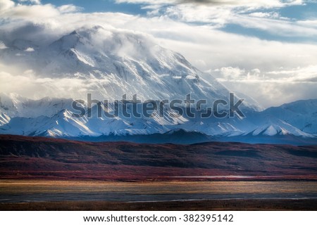 Denali (formerly Mt McKinley) rises miles above the vast low tundra near Kantishna, Alaska Royalty-Free Stock Photo #382395142