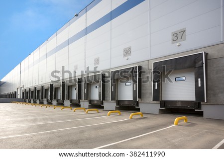 A Large distribution warehouse with gates for loading goods Royalty-Free Stock Photo #382411990