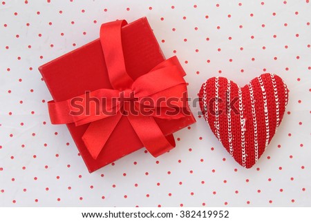 Gift box and heart on polka dot background in vintage style