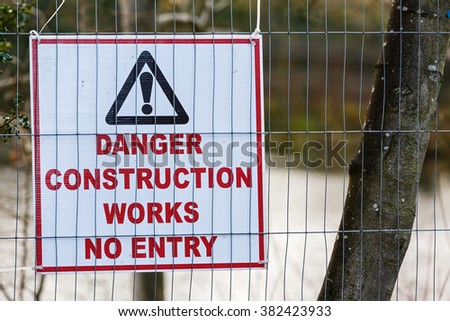 Danger no entry warning board on fence