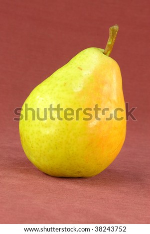 Picture of green pear on red background.