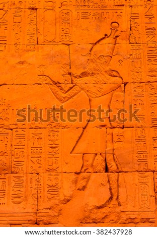 Authentic Hieroglyphic illustration of the Egyptian god on the wall in a temple