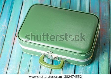 full boho suitcase on a distressed blue background