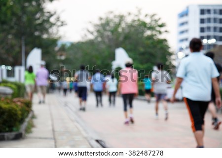blurred background of people walking in the park