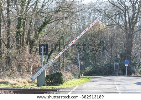 Opening Railway barriers at the level crossing in Germany.