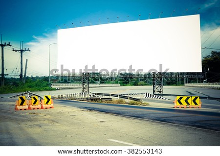 billboard on bridge with road and blue sky background